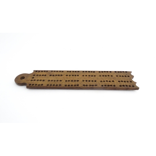 1171 - Treen : A 19thC oak cribbage board. Approx. 13 1/4