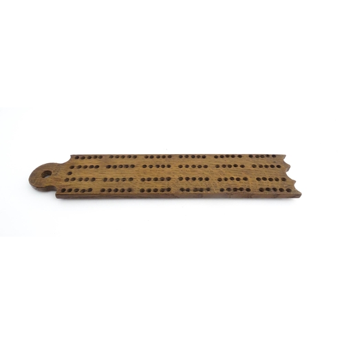 1171 - Treen : A 19thC oak cribbage board. Approx. 13 1/4