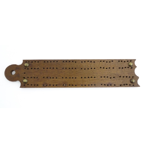 1171 - Treen : A 19thC oak cribbage board. Approx. 13 1/4