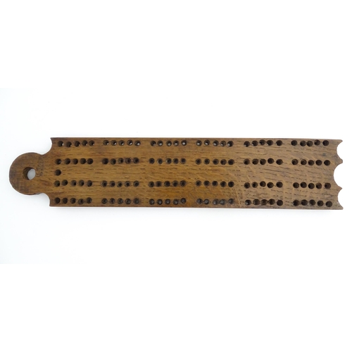 1171 - Treen : A 19thC oak cribbage board. Approx. 13 1/4