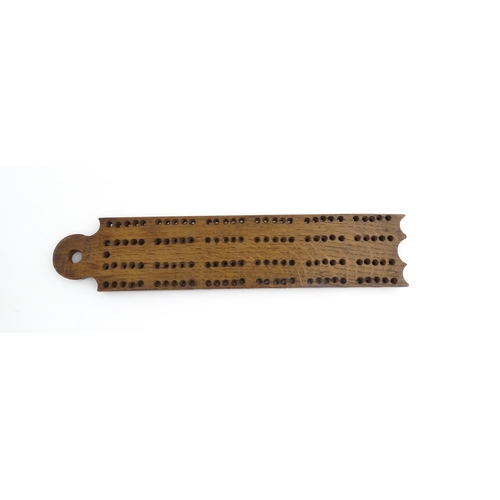 1171 - Treen : A 19thC oak cribbage board. Approx. 13 1/4