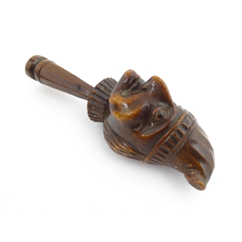 1172 - Treen : A 19thC Continental carved walnut nutcracker with figural head decoration. Approx. 5 3/4