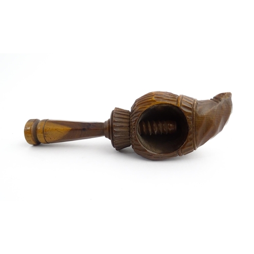 1172 - Treen : A 19thC Continental carved walnut nutcracker with figural head decoration. Approx. 5 3/4