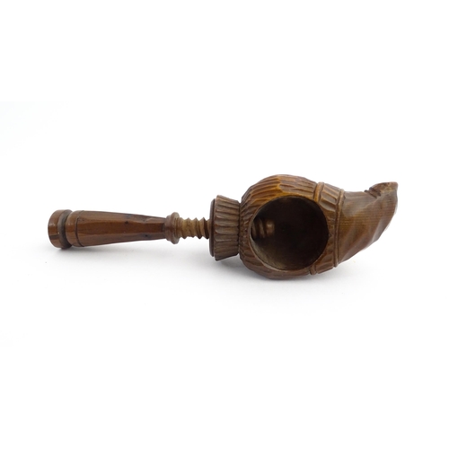 1172 - Treen : A 19thC Continental carved walnut nutcracker with figural head decoration. Approx. 5 3/4