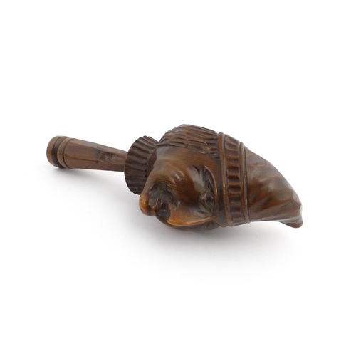 1172 - Treen : A 19thC Continental carved walnut nutcracker with figural head decoration. Approx. 5 3/4