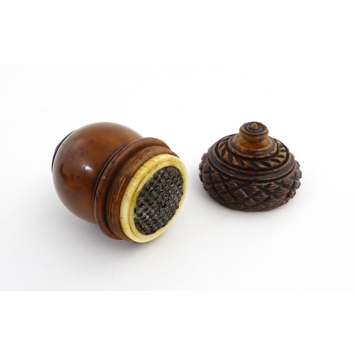 1176 - Treen : A 19thC carved coquilla nut nutmeg grater modelled as an acorn. Approx. 3