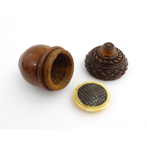 1176 - Treen : A 19thC carved coquilla nut nutmeg grater modelled as an acorn. Approx. 3