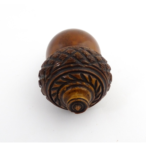 1176 - Treen : A 19thC carved coquilla nut nutmeg grater modelled as an acorn. Approx. 3