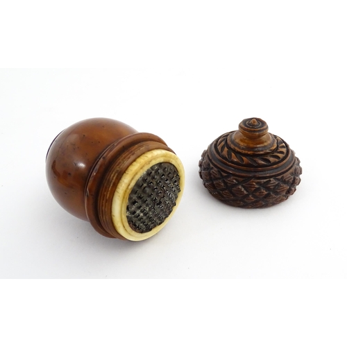 1176 - Treen : A 19thC carved coquilla nut nutmeg grater modelled as an acorn. Approx. 3