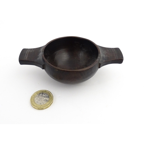 1177 - Treen : A 19thC Scottish turned oak quaich. Approx. 4 1/4