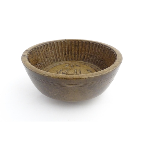 1180 - Treen : A 19thC sycamore flummery / pudding bowl / mould of circular form, having an interior with v... 