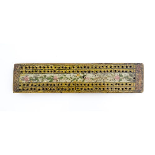 1181 - Treen : An 18thC naive cribbage board with hand painted decoration. Approx. 8