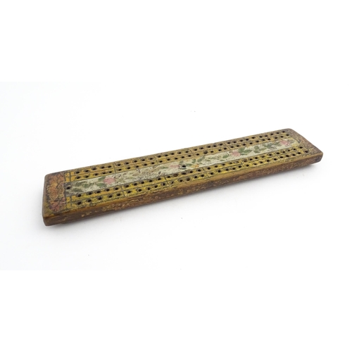 1181 - Treen : An 18thC naive cribbage board with hand painted decoration. Approx. 8