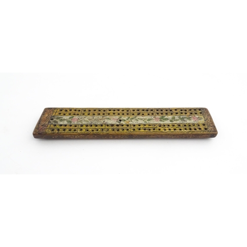 1181 - Treen : An 18thC naive cribbage board with hand painted decoration. Approx. 8