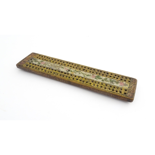 1181 - Treen : An 18thC naive cribbage board with hand painted decoration. Approx. 8