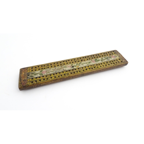 1181 - Treen : An 18thC naive cribbage board with hand painted decoration. Approx. 8