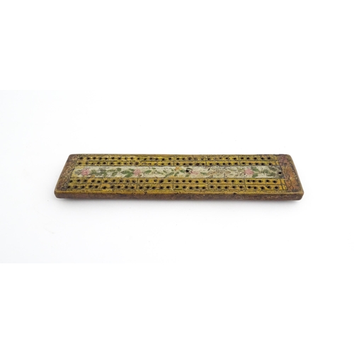 1181 - Treen : An 18thC naive cribbage board with hand painted decoration. Approx. 8