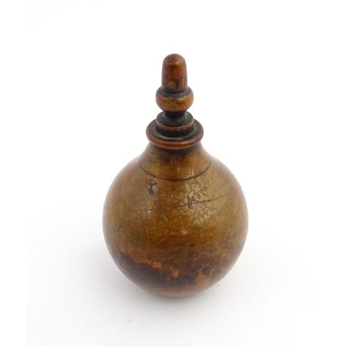 1184 - Treen : A 19thC treen spice flask shaped form, the acorn finial unscrewing to reveal a five hole sha... 