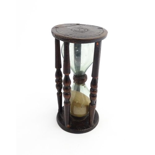 1185 - Treen : A 19thC sand timer, the wooden frame with turned uprights. Approx. 7 3/4