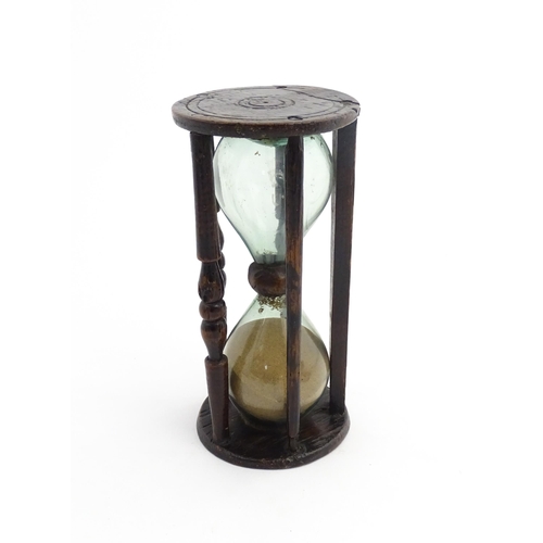 1185 - Treen : A 19thC sand timer, the wooden frame with turned uprights. Approx. 7 3/4