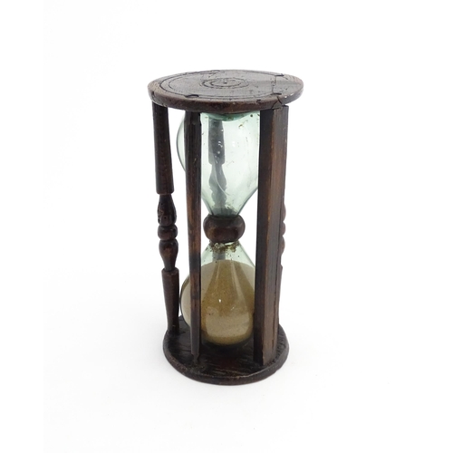 1185 - Treen : A 19thC sand timer, the wooden frame with turned uprights. Approx. 7 3/4