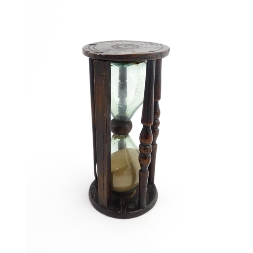 1185 - Treen : A 19thC sand timer, the wooden frame with turned uprights. Approx. 7 3/4