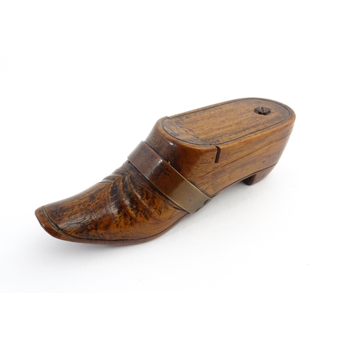 1195 - Treen : A 19thC treen novelty puzzle snuff box modelled as a shoe with copper band detail. Approx. 5... 