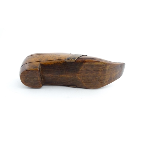 1195 - Treen : A 19thC treen novelty puzzle snuff box modelled as a shoe with copper band detail. Approx. 5... 