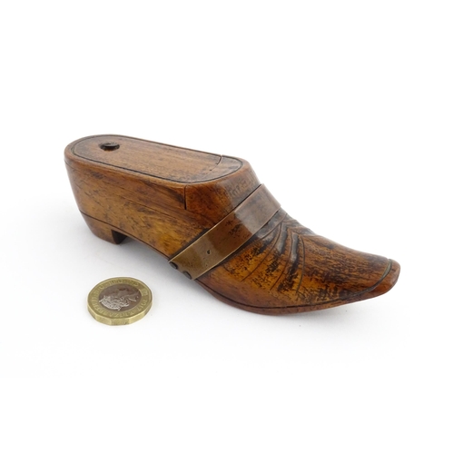 1195 - Treen : A 19thC treen novelty puzzle snuff box modelled as a shoe with copper band detail. Approx. 5... 