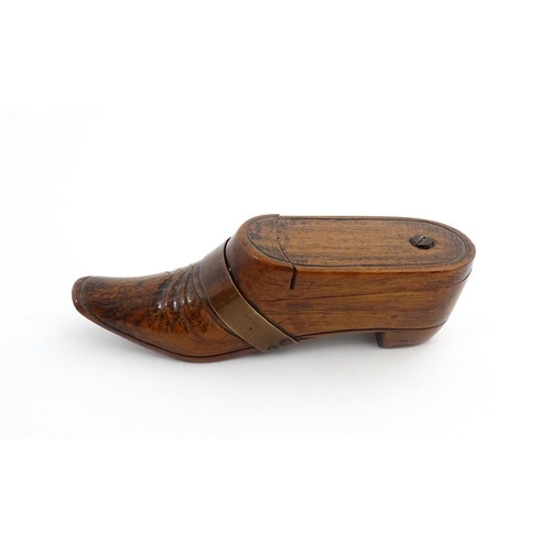 1195 - Treen : A 19thC treen novelty puzzle snuff box modelled as a shoe with copper band detail. Approx. 5... 