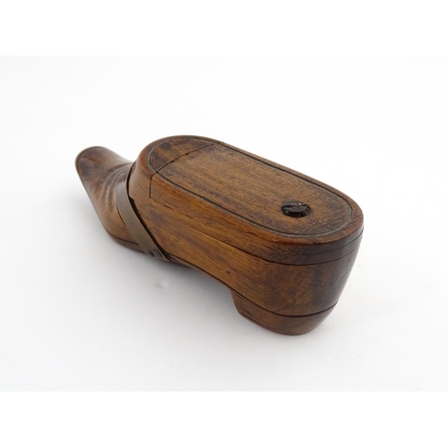 1195 - Treen : A 19thC treen novelty puzzle snuff box modelled as a shoe with copper band detail. Approx. 5... 