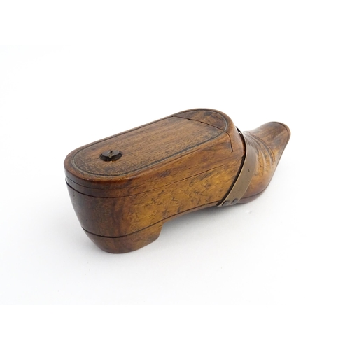 1195 - Treen : A 19thC treen novelty puzzle snuff box modelled as a shoe with copper band detail. Approx. 5... 