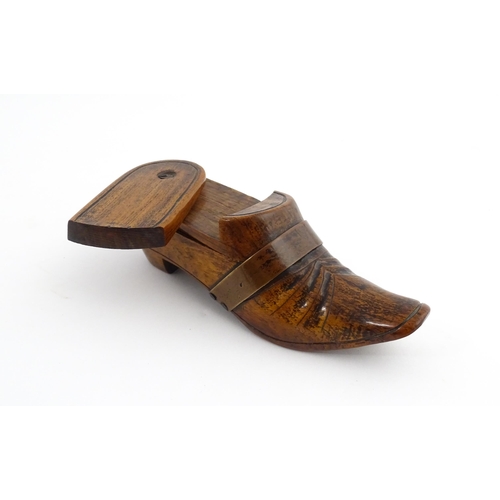 1195 - Treen : A 19thC treen novelty puzzle snuff box modelled as a shoe with copper band detail. Approx. 5... 