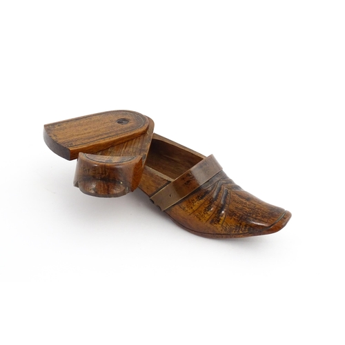 1195 - Treen : A 19thC treen novelty puzzle snuff box modelled as a shoe with copper band detail. Approx. 5... 