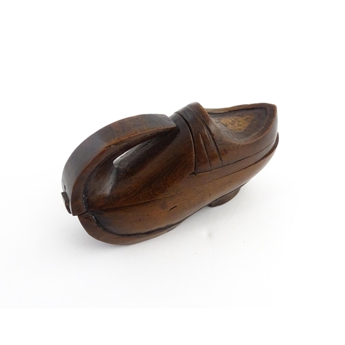 1196 - Treen : A 19thC Continental novelty puzzle snuff box modelled as a shoe with heart detail. Approx. 3... 