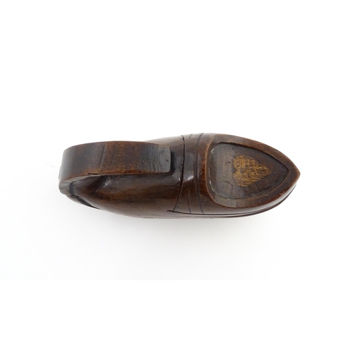 1196 - Treen : A 19thC Continental novelty puzzle snuff box modelled as a shoe with heart detail. Approx. 3... 