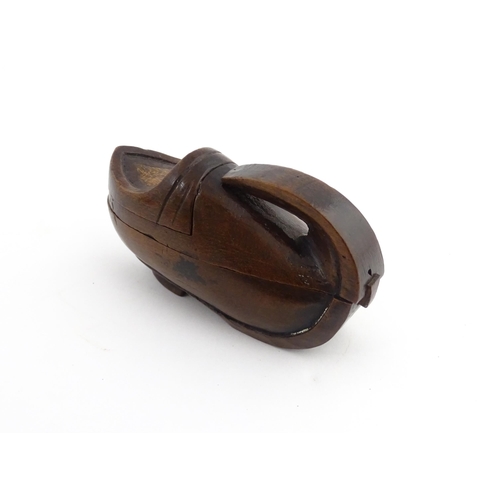 1196 - Treen : A 19thC Continental novelty puzzle snuff box modelled as a shoe with heart detail. Approx. 3... 