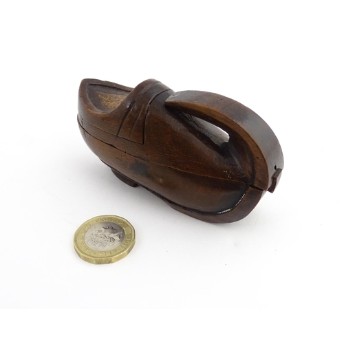 1196 - Treen : A 19thC Continental novelty puzzle snuff box modelled as a shoe with heart detail. Approx. 3... 