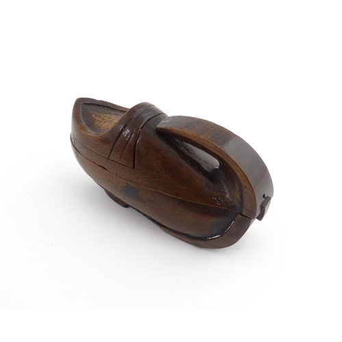 1196 - Treen : A 19thC Continental novelty puzzle snuff box modelled as a shoe with heart detail. Approx. 3... 