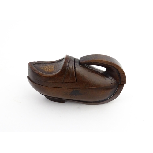 1196 - Treen : A 19thC Continental novelty puzzle snuff box modelled as a shoe with heart detail. Approx. 3... 