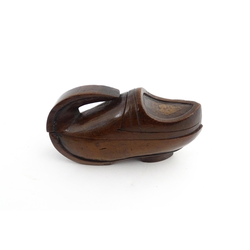 1196 - Treen : A 19thC Continental novelty puzzle snuff box modelled as a shoe with heart detail. Approx. 3... 