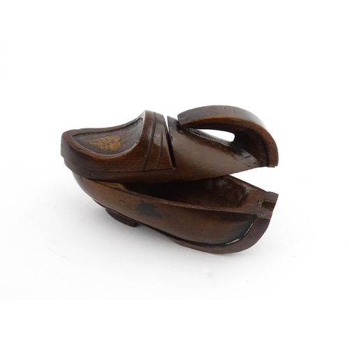 1196 - Treen : A 19thC Continental novelty puzzle snuff box modelled as a shoe with heart detail. Approx. 3... 