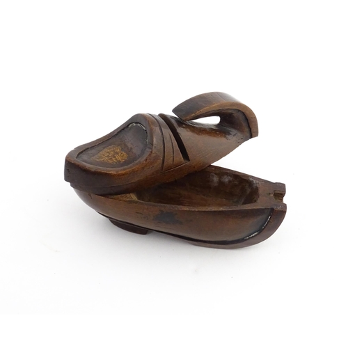 1196 - Treen : A 19thC Continental novelty puzzle snuff box modelled as a shoe with heart detail. Approx. 3... 