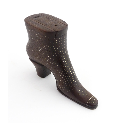 1197 - Treen : A carved shoe snuff box modelled as a heeled boot with sliding top and inlaid brass detail. ... 