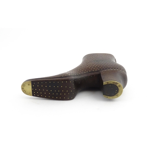 1197 - Treen : A carved shoe snuff box modelled as a heeled boot with sliding top and inlaid brass detail. ... 