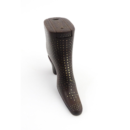 1197 - Treen : A carved shoe snuff box modelled as a heeled boot with sliding top and inlaid brass detail. ... 