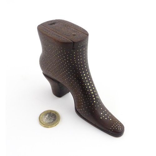 1197 - Treen : A carved shoe snuff box modelled as a heeled boot with sliding top and inlaid brass detail. ... 