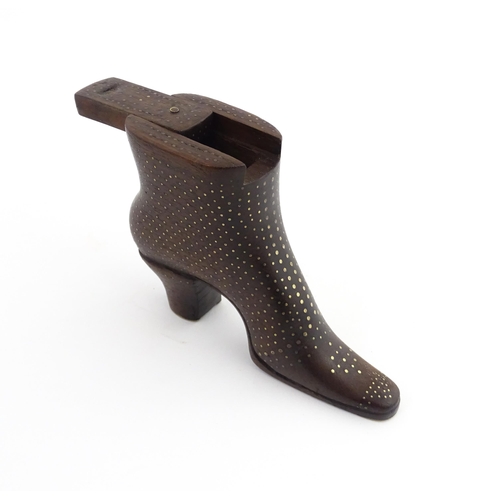 1197 - Treen : A carved shoe snuff box modelled as a heeled boot with sliding top and inlaid brass detail. ... 