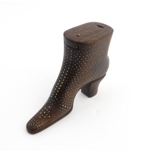 1197 - Treen : A carved shoe snuff box modelled as a heeled boot with sliding top and inlaid brass detail. ... 