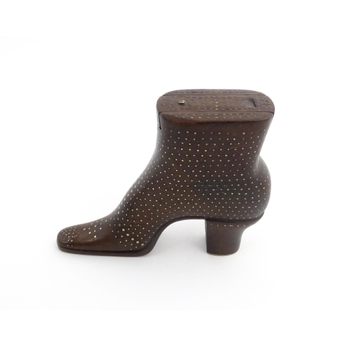 1197 - Treen : A carved shoe snuff box modelled as a heeled boot with sliding top and inlaid brass detail. ... 